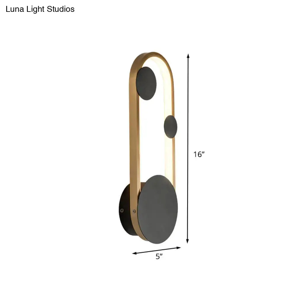 Modern gold metallic wall lamp with three matte black circular accents and sleek minimalist design for bedroom lighting