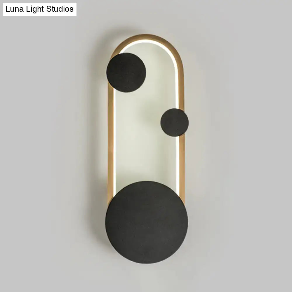 Modern black and gold metallic wall lamp with sleek frame, glowing led strip, and matte black circular accents