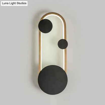 Modern black and gold metallic wall lamp with sleek frame, glowing led strip, and matte black circular accents