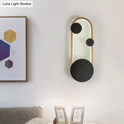 Modern black and gold metallic wall lamp with three matte black circular accents for bedroom led light fixture