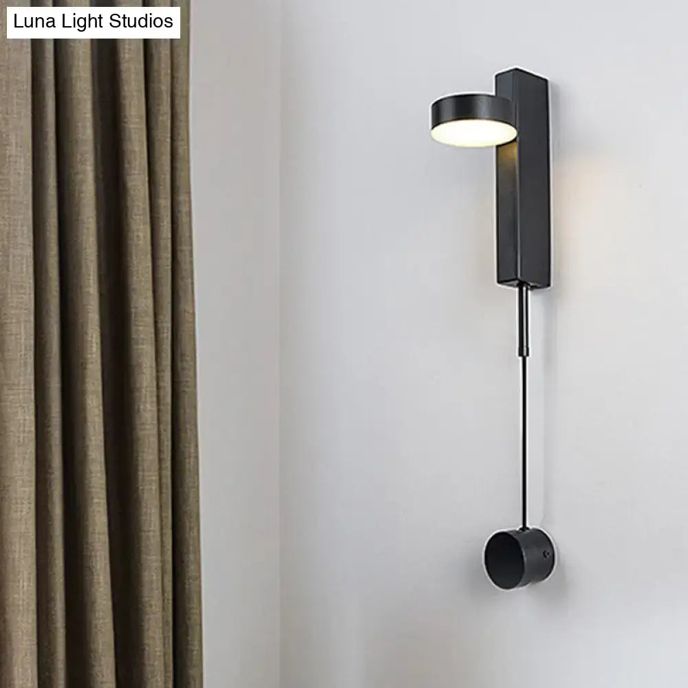 Modern black and gold metallic wall lighting featuring a flush mount wall sconce with sleek cylindrical light and pendant