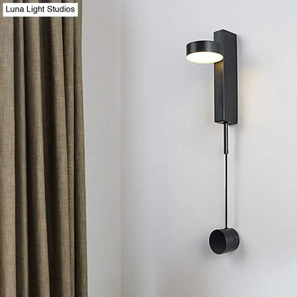 Modern black and gold metallic wall lighting featuring a flush mount wall sconce with sleek cylindrical light and pendant