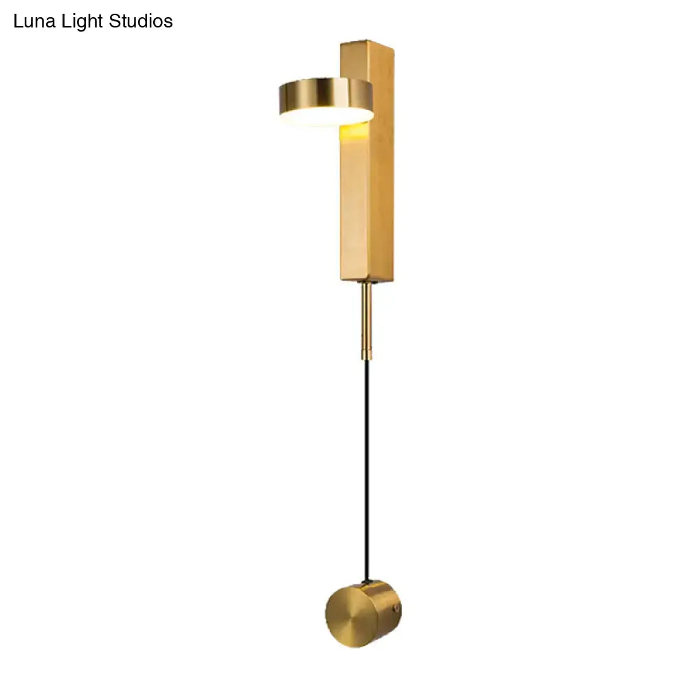 Modern black and gold metallic flush mount wall sconce with rectangular backplate and hanging spherical base for bedroom lighting