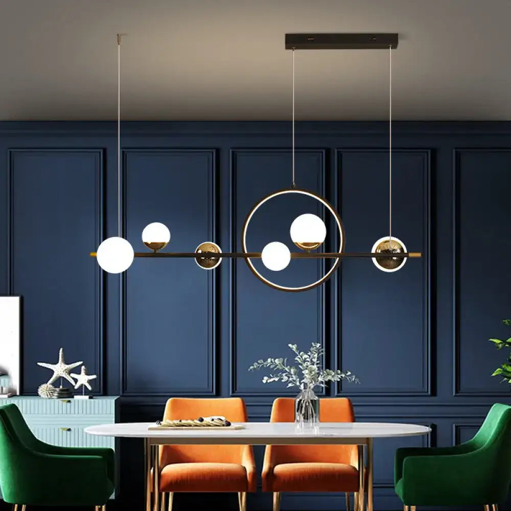 DecorBites modern black acrylic sphere led pendant light with gold-toned frame and white glass bulbs ideal for restaurants