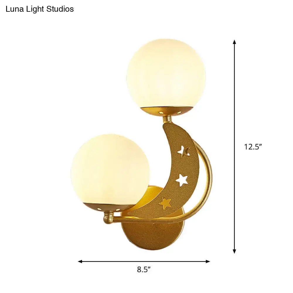 Gold-toned crescent moon wall lamp with milky glass ball shades and star cutouts for modern bedroom lighting