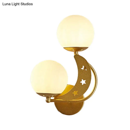 Gold-toned crescent moon wall lamp with milky glass ball shades and star cutouts for modern bedroom lighting