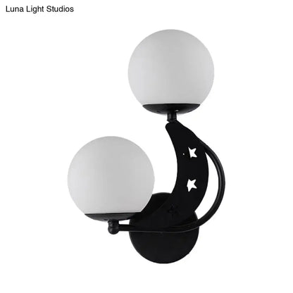 Modern black and gold crescent moon wall lamp with milky glass ball shades and star cutouts for bedroom lighting