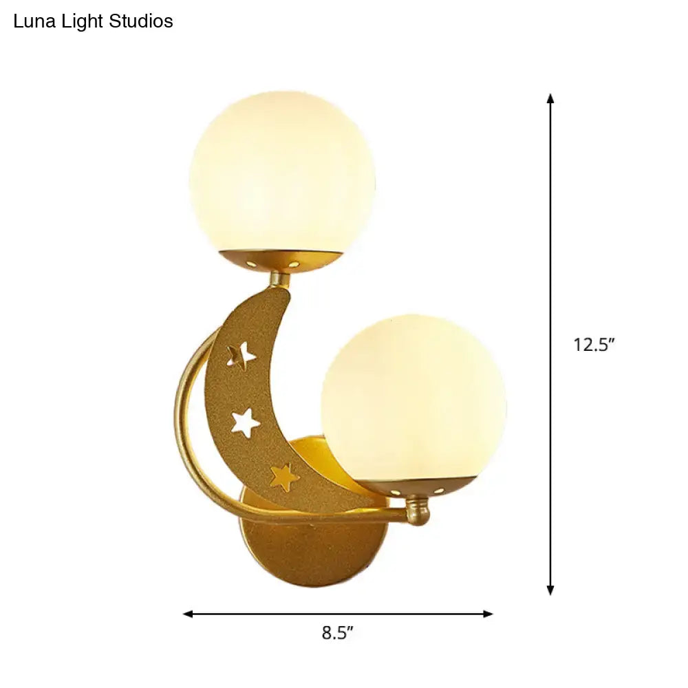 Gold-toned crescent moon wall lamp with milky glass ball shades and star cutouts for bedroom lighting