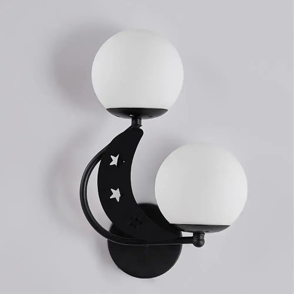 Modern black crescent moon wall lamp with milky glass ball shades and star cutouts for bedroom lighting
