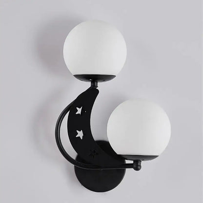 Modern black crescent moon wall lamp with milky glass ball shades and star cutouts for bedroom lighting