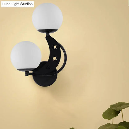 Modern black and gold crescent moon wall lamp with milky glass ball shades and star cutouts for bedroom lighting