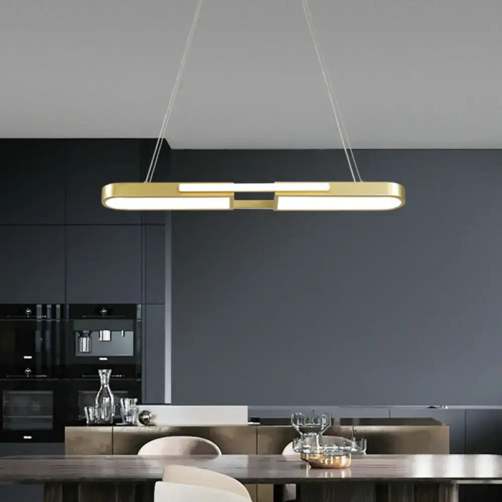 Modern gold-toned oblong acrylic pendant light with integrated led warm white lighting for dining room use