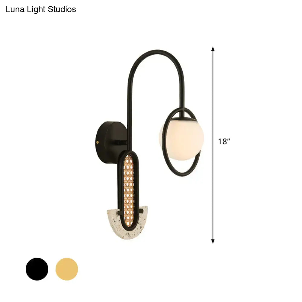 Modern black metal wall sconce with curved arm, opal glass ball shade, textured concrete base, 110v-120v and 220v-240v compatible