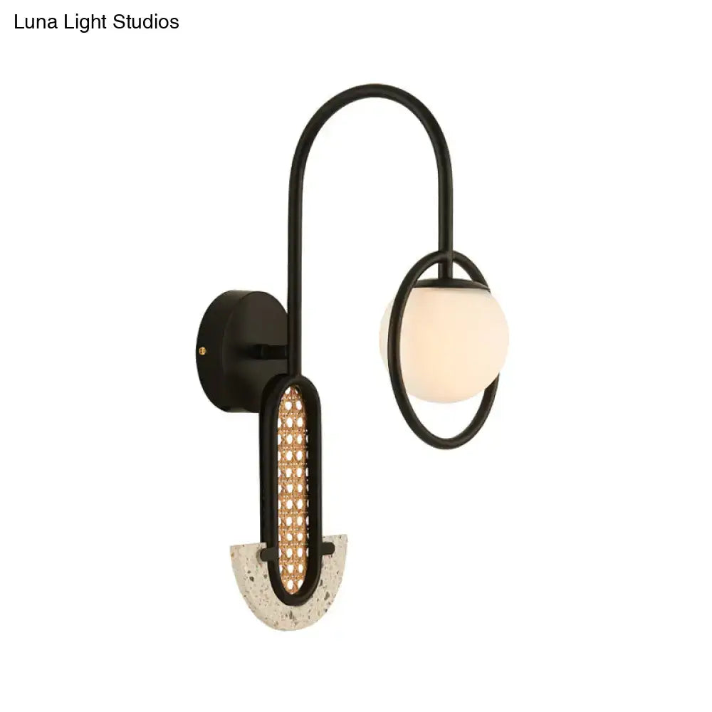 Modern black metal wall sconce with curved arm, oval woven rattan panel, and frosted opal glass ball shade for 110v-120v 220v-240v use