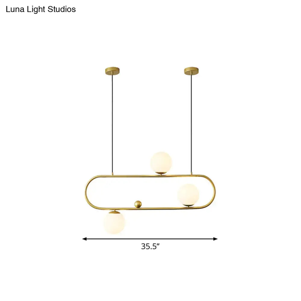 Modern black gold pendant light with three frosted opal glass globes for dining room ceiling or island lighting