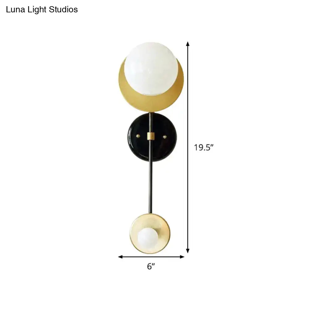 Modern black and gold wall light fixture with opal glass spheres on adjustable rod for bedroom sconce lighting
