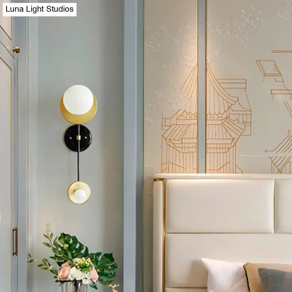 Modern black and gold opal glass wall light fixture with three spherical glass shades for bedroom sconce lighting