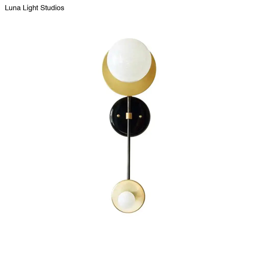Modern black and gold opal glass wall light fixture with white glass globe and crescent design for bedroom sconce