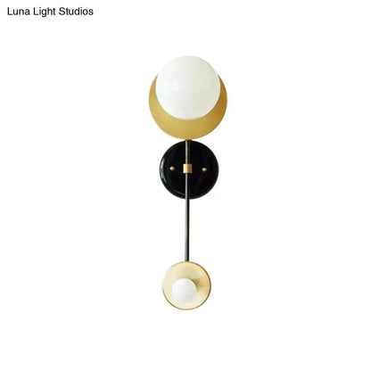 Modern black and gold opal glass wall light fixture with white glass globe and crescent design for bedroom sconce