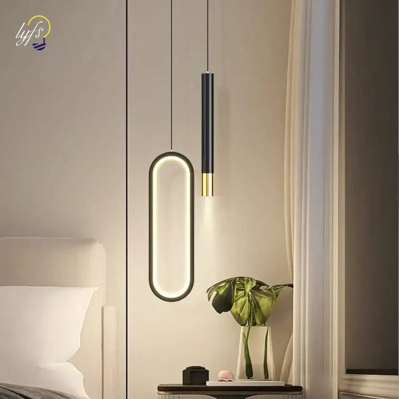 Modern black and gold oval pendant light with sleek design providing white light source for dining room use