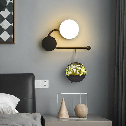 Modern black and gold brass planter sconce with glowing white bulb and black accents for 110v-120v living room lighting