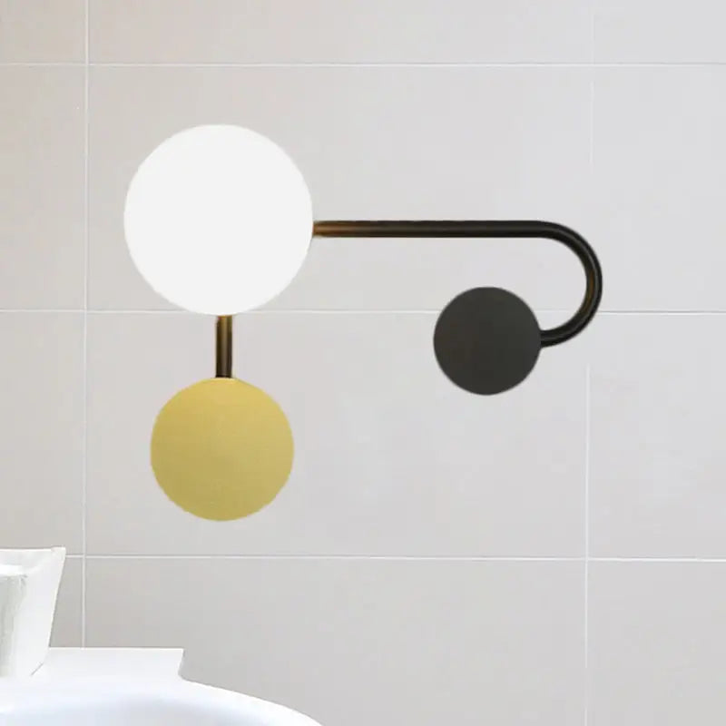 Modern black and gold wall-mounted planter sconce with matte black arm and three 110v-120v spherical shades