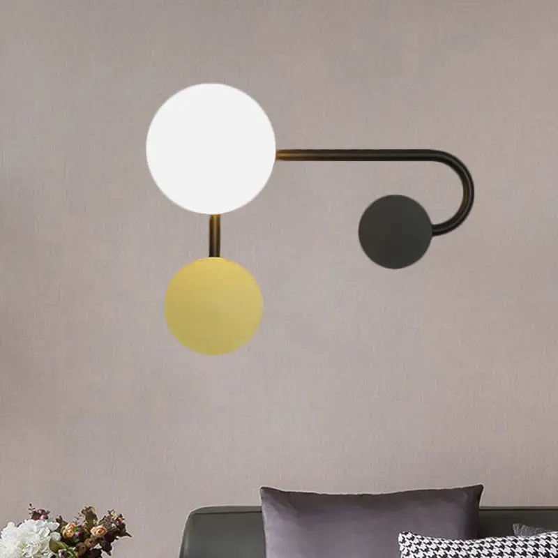 Modern black and gold planter sconce with sleek black metal arm and three glass shades in 110v-120v use