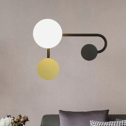 Modern black and gold planter sconce with sleek black metal arm and three glass shades in 110v-120v use