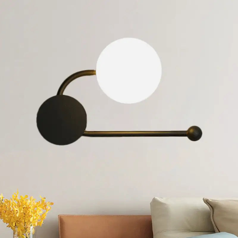 Modern black and gold planter sconce with curved brass arm white glass shade and black base for 110v-120v lighting