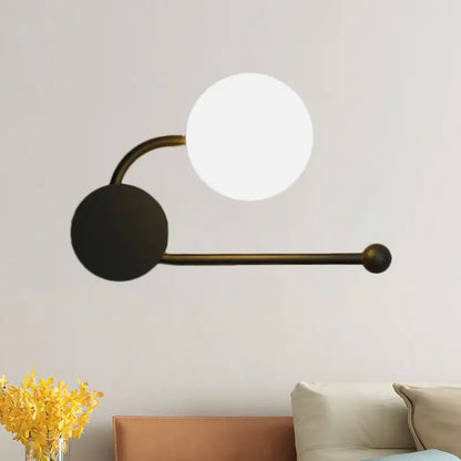Modern black and gold planter sconce with curved brass arm white glass shade and black base for 110v-120v lighting