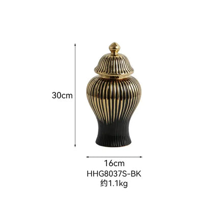 A sleek black and gold ceramic ginger jar vase with ribbed design and matching golden lid for living room decor