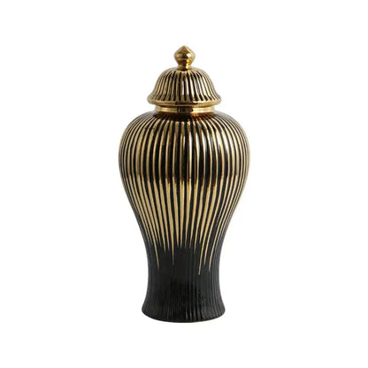 A sleek black and gold ceramic ginger jar vase with vertical ribbed detailing and a matching golden lid for living room decor