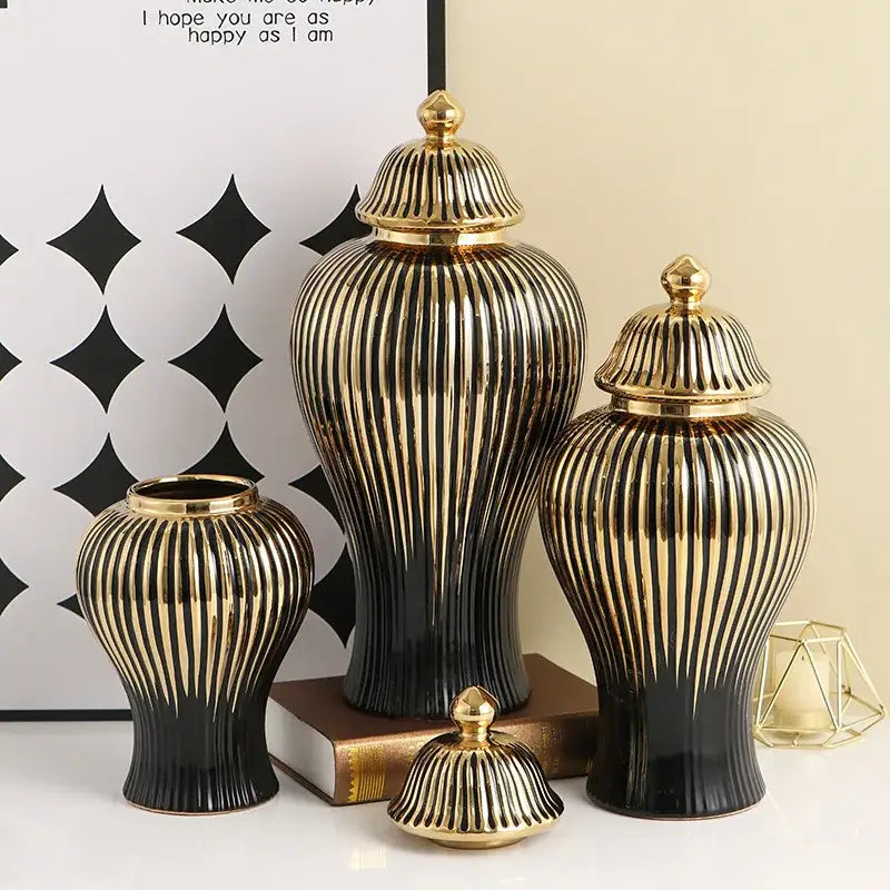 Set of three elegant black and gold ceramic ribbed ginger jar vases with matching golden lids for living room decor
