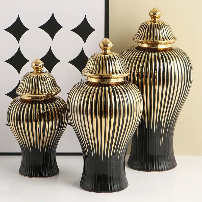 Set of three modern black and gold ribbed ceramic ginger jar vases with matching golden lids for living room decor