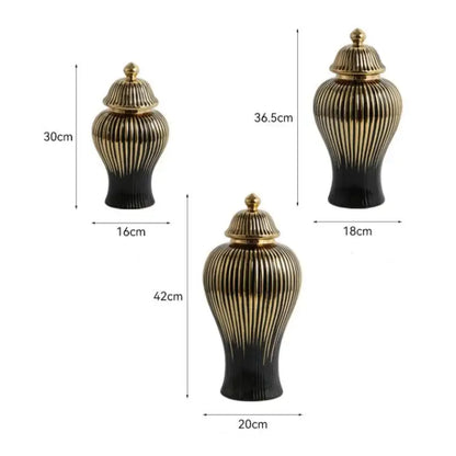 Set of three modern black and gold ceramic ginger jar vases with ribbed vertical patterns and matching golden lids