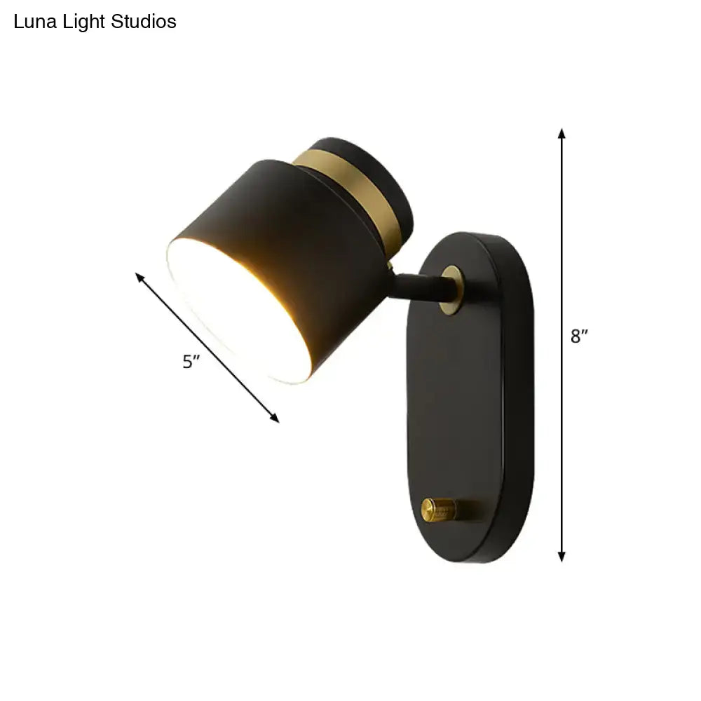 Modern black and brass accent wall sconce with rotatable cylindrical led light for bedroom use