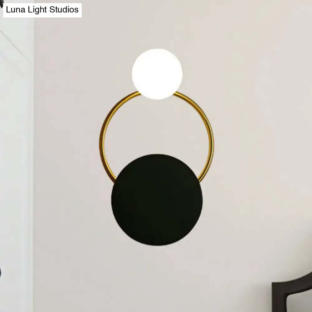 Modern black and gold round wall sconce with direct wired electric installation featuring sleek gold round wall frame and spheres