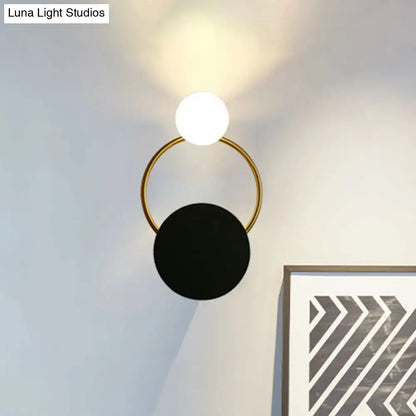 Modern black and gold round wall sconce with a gold-toned circular frame and two spherical shades, direct wired electric