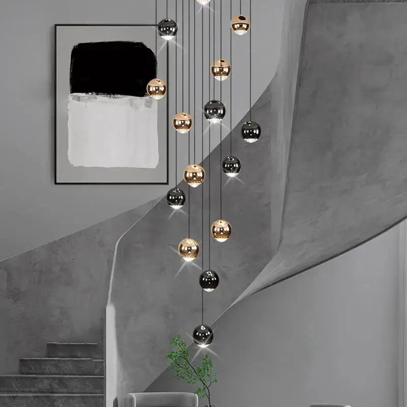 Modern black and gold spherical pendant light made of ironware alloy for staircase featuring polished bulbs in modern interiors