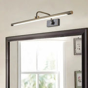 A modern black and gold swing arm wall light with a brushed brass finish and rectangular black mounting plate vanity light