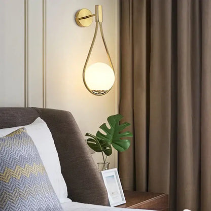 Modern black and gold teardrop led wall sconce with frosted glass globe for bedroom lighting