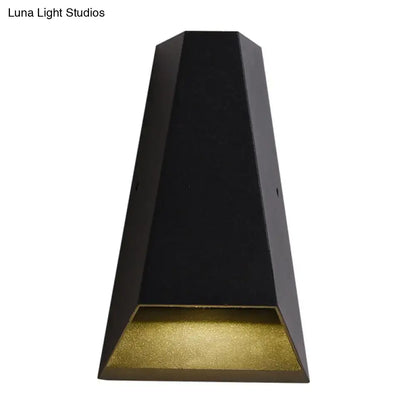 Modern black hexagonal led wall light with gold textured diffuser providing warm white light for bedroom use