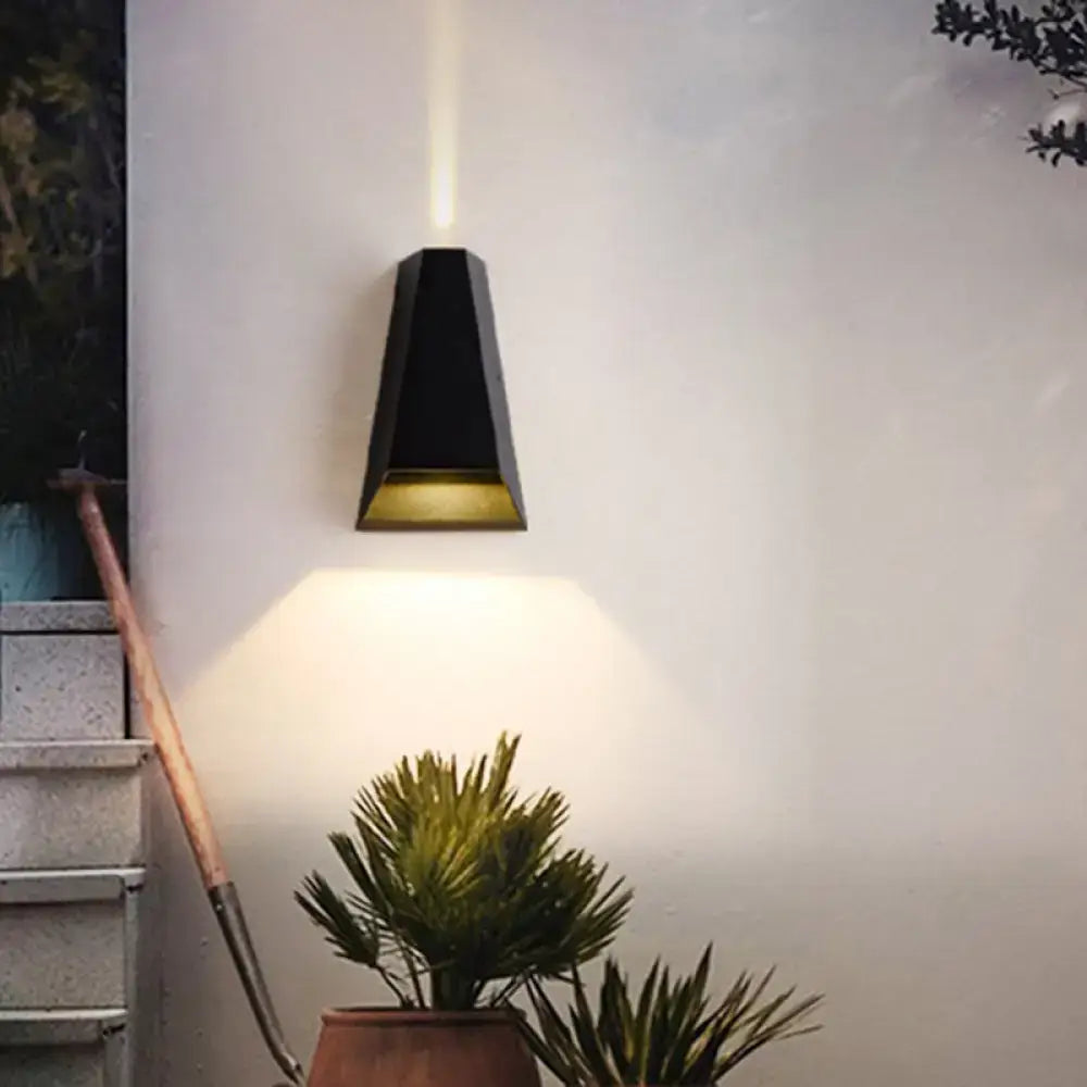 Modern black and gold geometric led wall light with warm white light and downward-facing beam for bedroom use