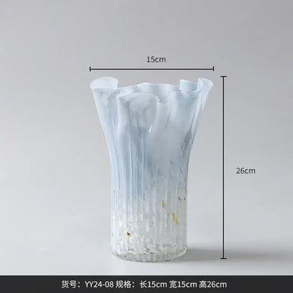 Translucent light blue glass vase with fluted ruffled rim and ribbed texture complementing decorbites golden trumpet ceramic set