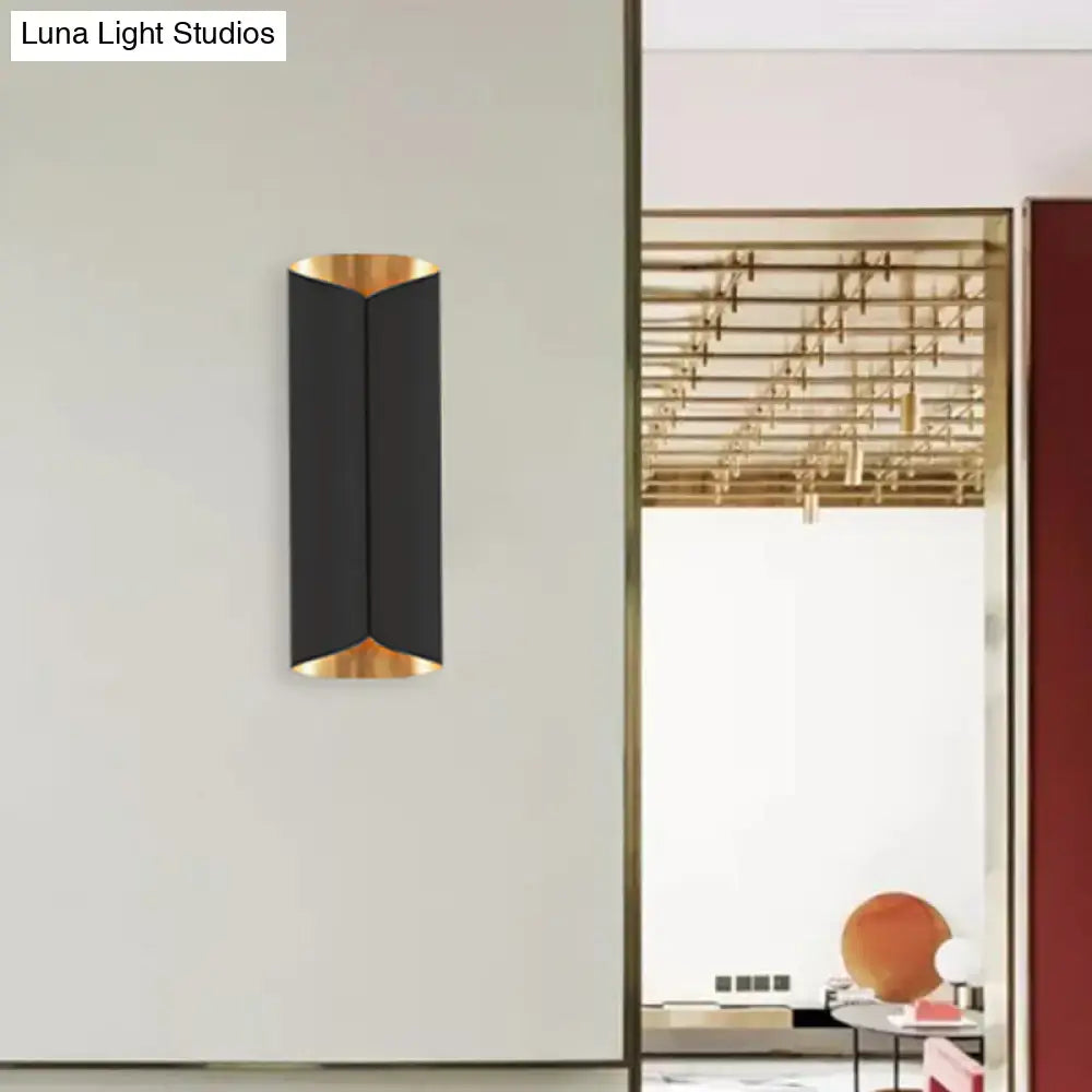 Modern black and gold twisted light fixture porch wall sconce with sleek curved design and bulb base detail