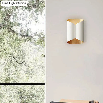 Modern black and gold twisted light fixture porch wall sconce with sleek curved design and bulb base metallic finishes