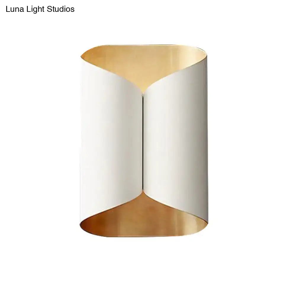 Modern black and gold twisted light fixture porch wall sconce with sleek curved exterior and warm gold bulb base lining
