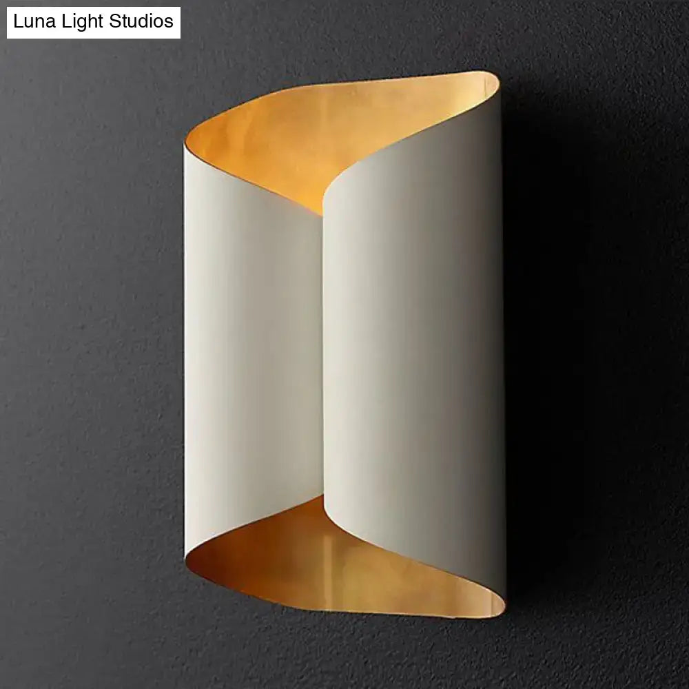 Modern black and gold twisted porch wall sconce light fixture with sleek curved design and off-white exterior bulb base