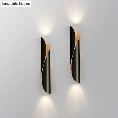 Modern black and gold twisted wall sconce with leaf-shaped design ideal for corridor wall sconce light fixtures