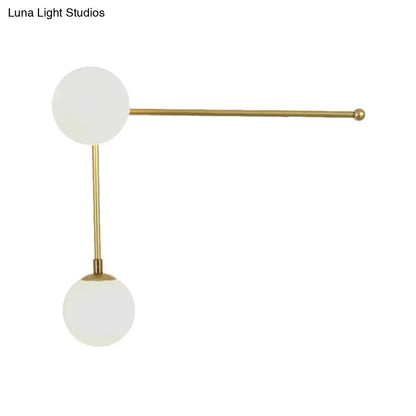 Modern black and gold wall lamp with direct wired electric brass fixture and two frosted glass spheres in modern design